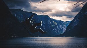 Preview wallpaper astronaut, cosmonaut, space suit, fall, photoshop, lake, mountains, dark