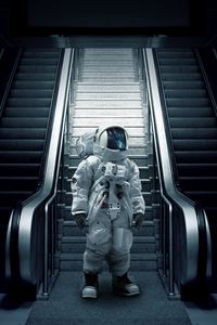 Preview wallpaper astronaut, cosmonaut, spacesuit, escalator, stairs