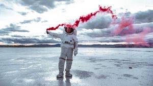 Preview wallpaper astronaut, spacesuit, colored smoke, sky