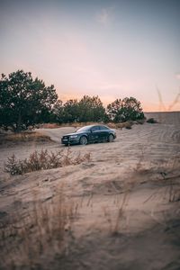 Preview wallpaper audi, car, sand, trees