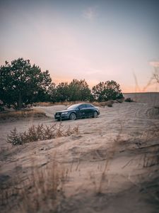 Preview wallpaper audi, car, sand, trees
