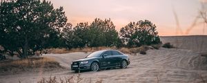 Preview wallpaper audi, car, sand, trees