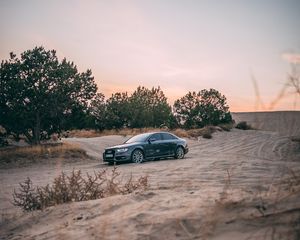 Preview wallpaper audi, car, sand, trees