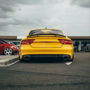 Preview wallpaper audi, car, yellow, back view, road