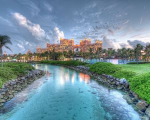 Preview wallpaper bahamas, island, landscape, rocks, grass, tree, water, sky, clouds, buildings, hdr