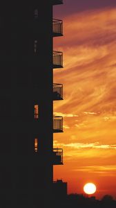 Preview wallpaper balcony, sunset, sky, skyline, city