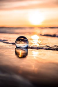 Preview wallpaper ball, coast, sunset, sea, reflection