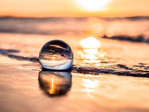 Preview wallpaper ball, coast, sunset, sea, reflection