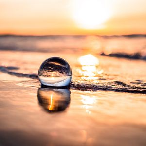 Preview wallpaper ball, coast, sunset, sea, reflection