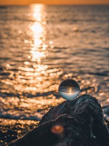 Preview wallpaper ball, glass, glare, sea, sunset