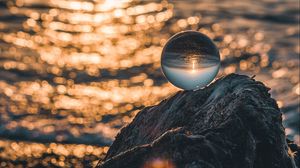Preview wallpaper ball, glass, glare, sea, sunset