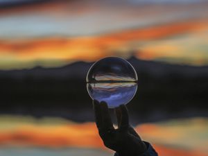 Preview wallpaper ball, glass, hand, blur