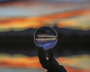 Preview wallpaper ball, glass, hand, blur