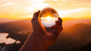 Preview wallpaper ball, glass, hand, sunset