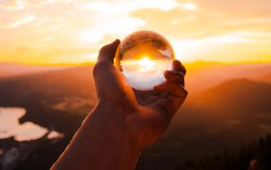 Preview wallpaper ball, glass, hand, sunset