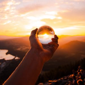 Preview wallpaper ball, glass, hand, sunset