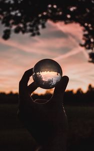 Preview wallpaper ball, glass, hand, sunset, transparent