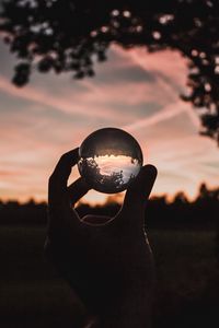 Preview wallpaper ball, glass, hand, sunset, transparent