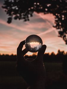 Preview wallpaper ball, glass, hand, sunset, transparent