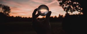 Preview wallpaper ball, glass, hand, sunset, transparent