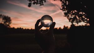 Preview wallpaper ball, glass, hand, sunset, transparent