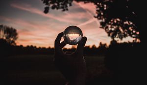 Preview wallpaper ball, glass, hand, sunset, transparent