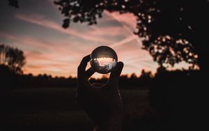 Preview wallpaper ball, glass, hand, sunset, transparent