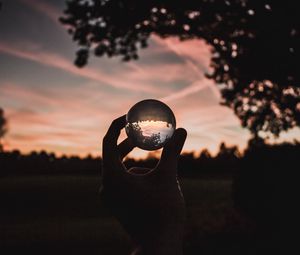 Preview wallpaper ball, glass, hand, sunset, transparent