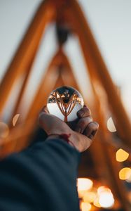 Preview wallpaper ball, glass, hand, reflection, blur