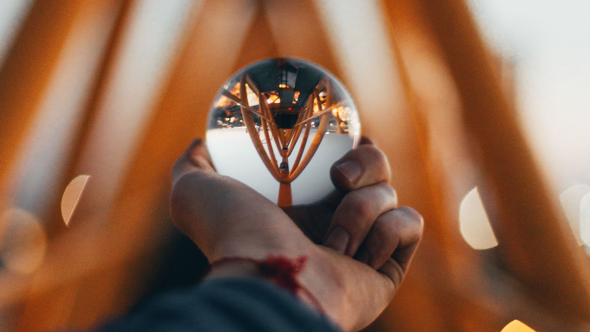 Download wallpaper 1920x1080 ball, glass, hand, reflection, blur full