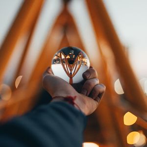 Preview wallpaper ball, glass, hand, reflection, blur