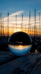 Preview wallpaper ball, glass, reflection, sunset, pier