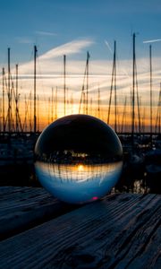 Preview wallpaper ball, glass, reflection, sunset, pier