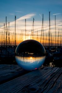 Preview wallpaper ball, glass, reflection, sunset, pier