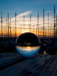 Preview wallpaper ball, glass, reflection, sunset, pier