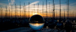 Preview wallpaper ball, glass, reflection, sunset, pier