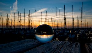 Preview wallpaper ball, glass, reflection, sunset, pier