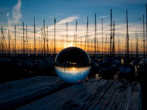 Preview wallpaper ball, glass, reflection, sunset, pier