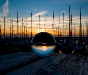 Preview wallpaper ball, glass, reflection, sunset, pier