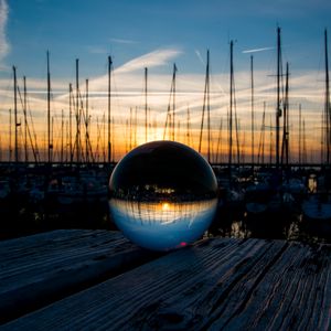 Preview wallpaper ball, glass, reflection, sunset, pier