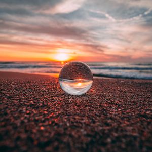 Preview wallpaper ball, glass, reflection, sea, sunset, shore