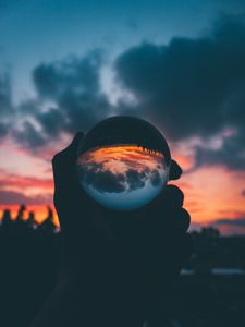 Preview wallpaper ball, glass, sunset, hand, reflection