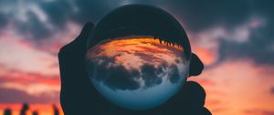 Preview wallpaper ball, glass, sunset, hand, reflection