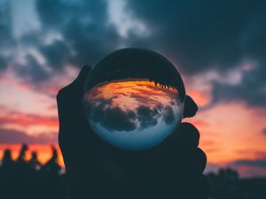 Preview wallpaper ball, glass, sunset, hand, reflection