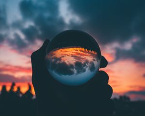 Preview wallpaper ball, glass, sunset, hand, reflection