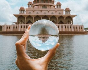 Preview wallpaper ball, hand, building, reflection, illusion