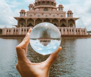 Preview wallpaper ball, hand, building, reflection, illusion