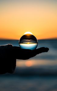 Preview wallpaper ball, hand, horizon, glass
