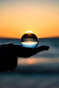 Preview wallpaper ball, hand, horizon, glass
