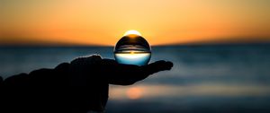 Preview wallpaper ball, hand, horizon, glass